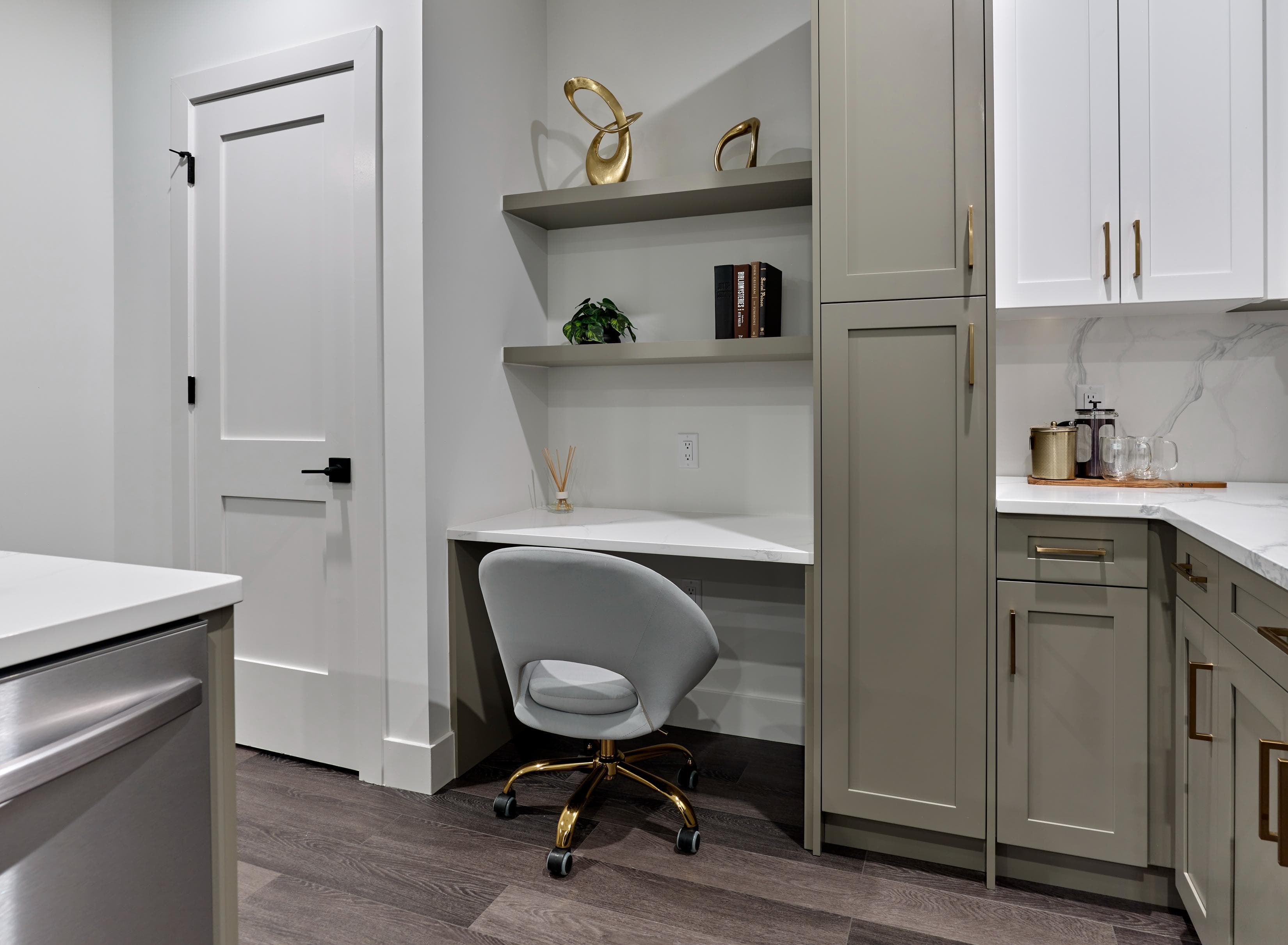 A white chair is in front of a desk in a kitchen.