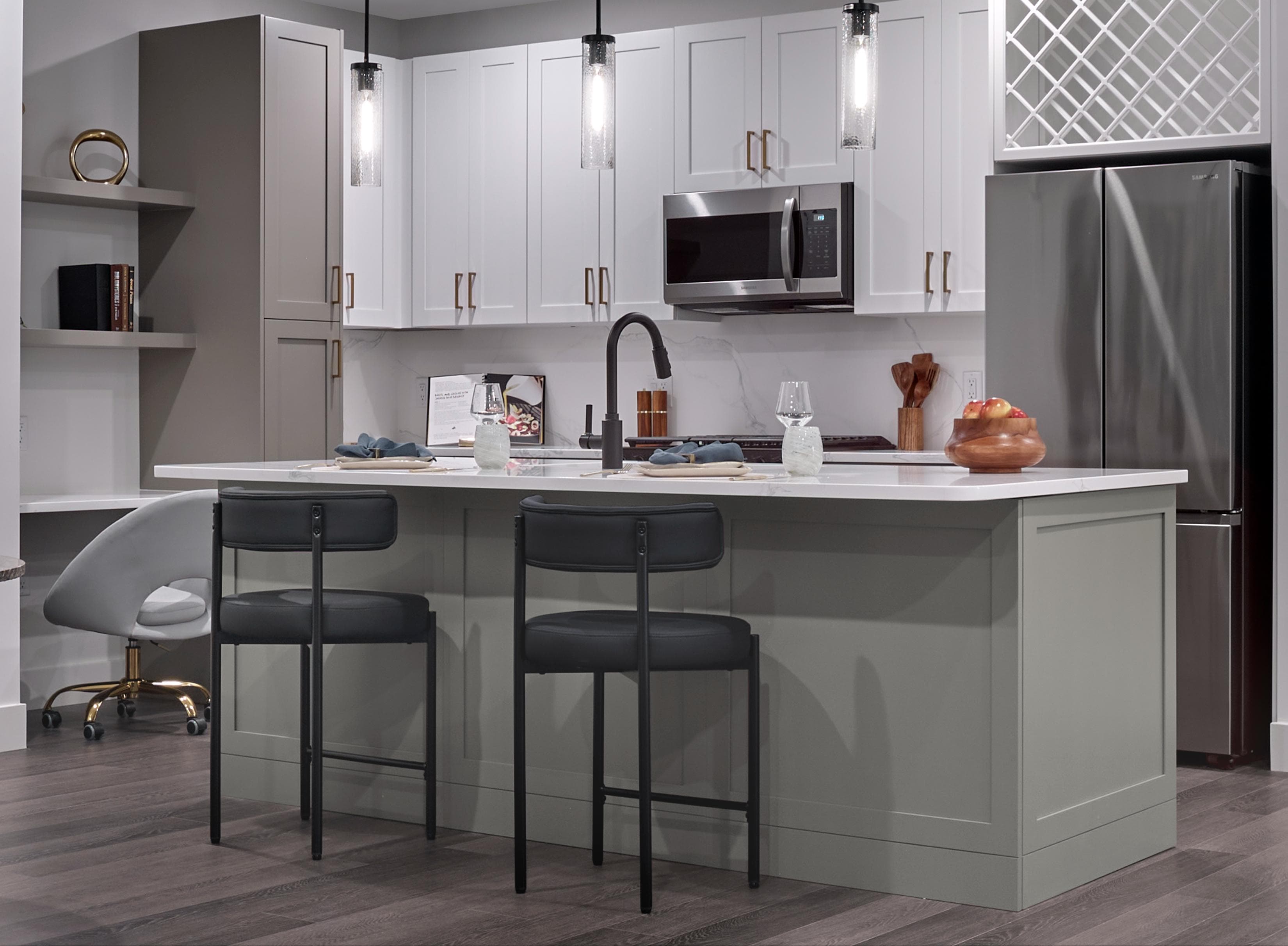 A kitchen with a white counter and black bar stools.