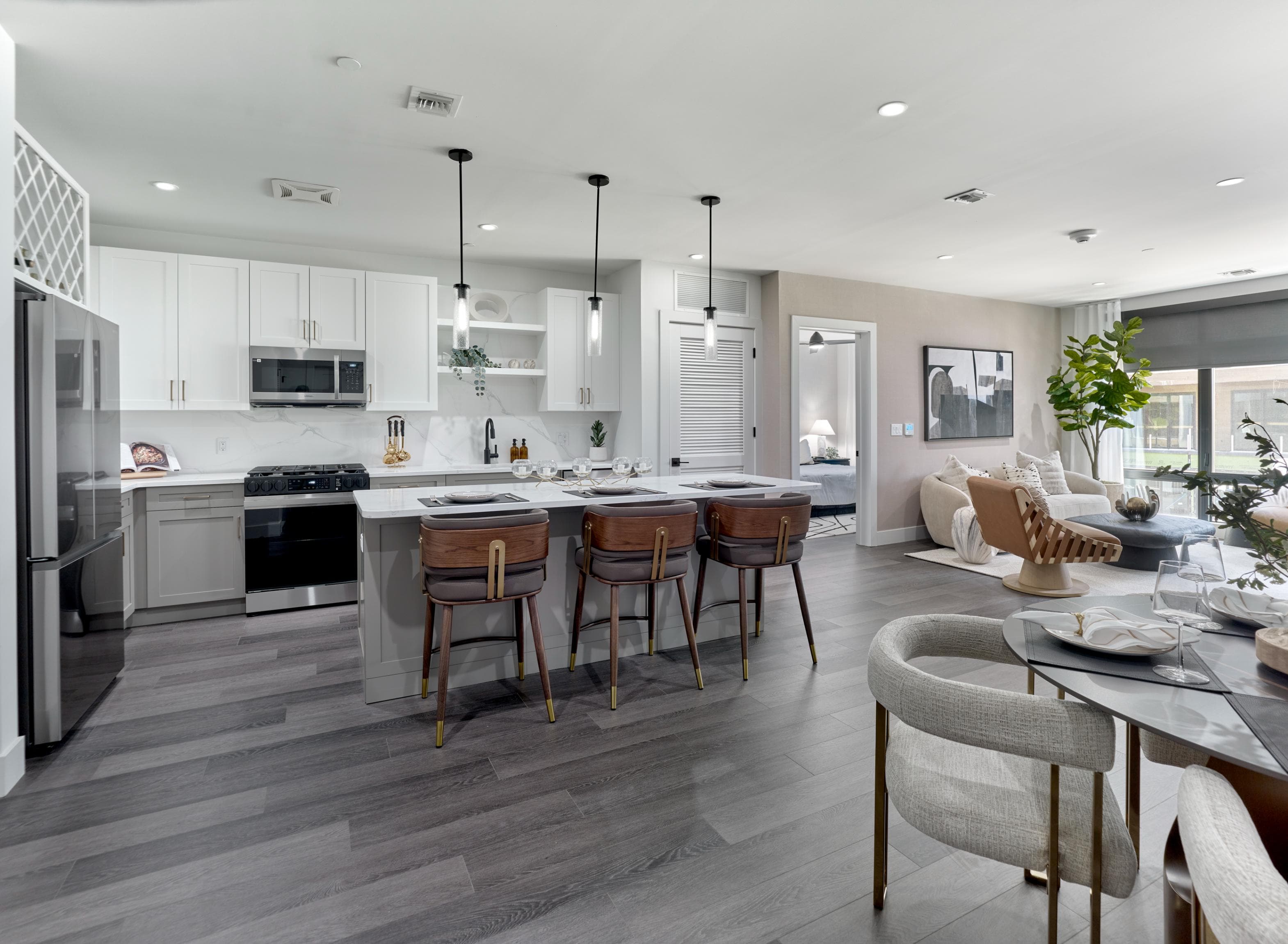 A modern kitchen with a dining area and a living room.