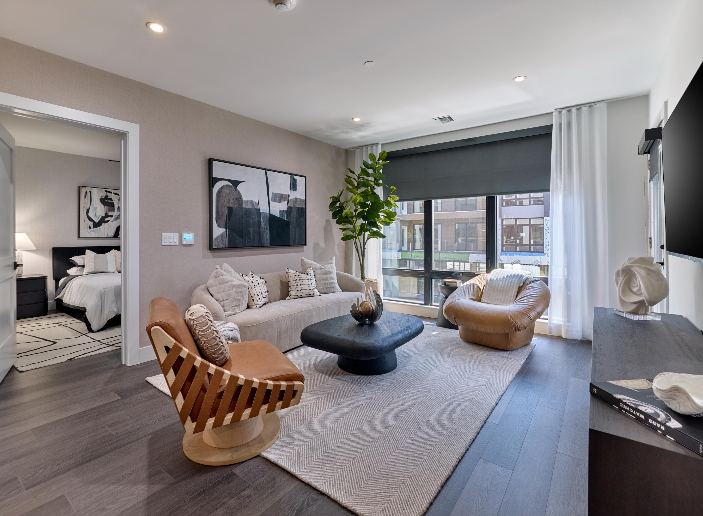 A modern living room with a large window and a flat screen TV.
