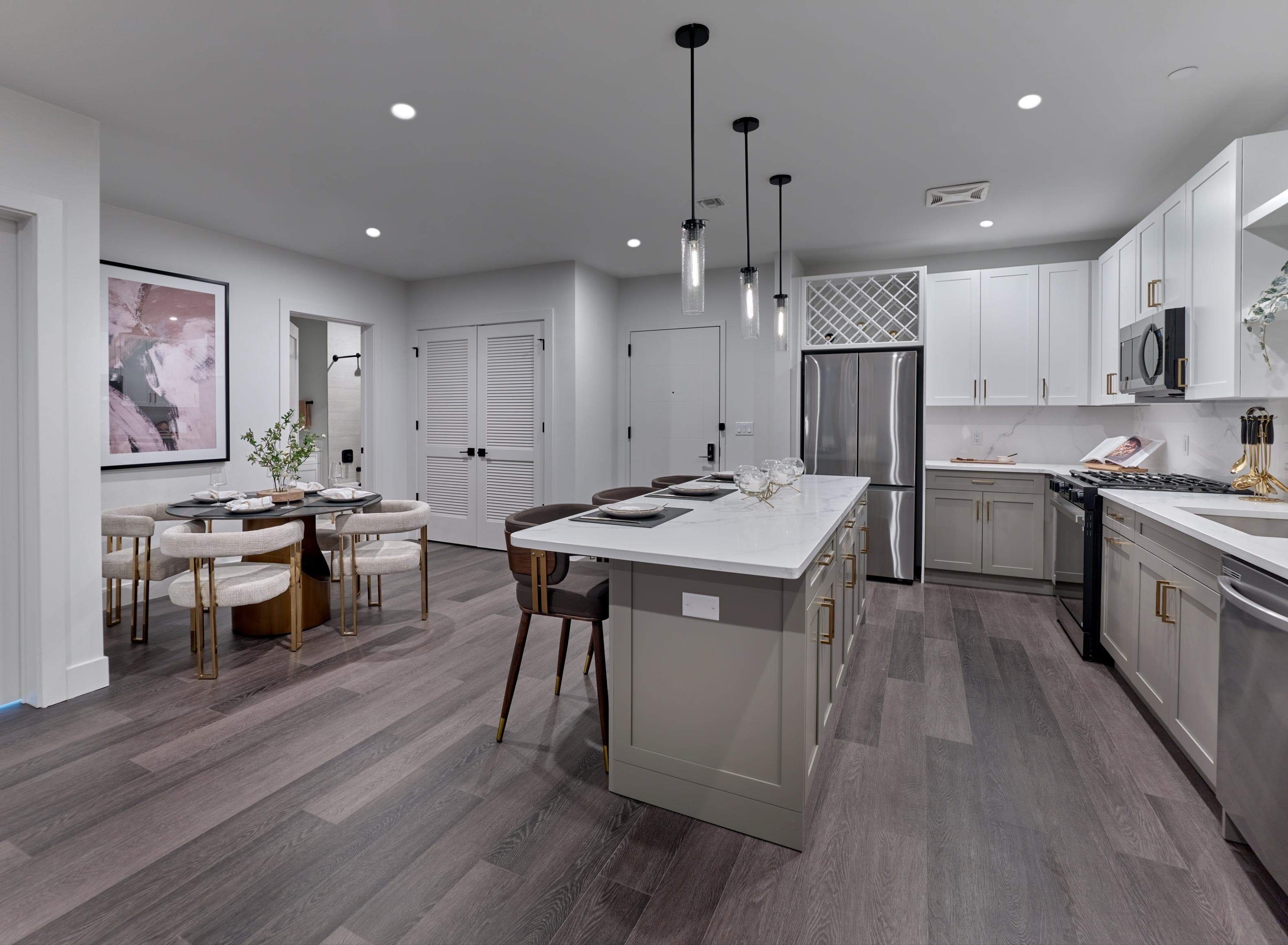 A modern kitchen with a dining table and chairs.