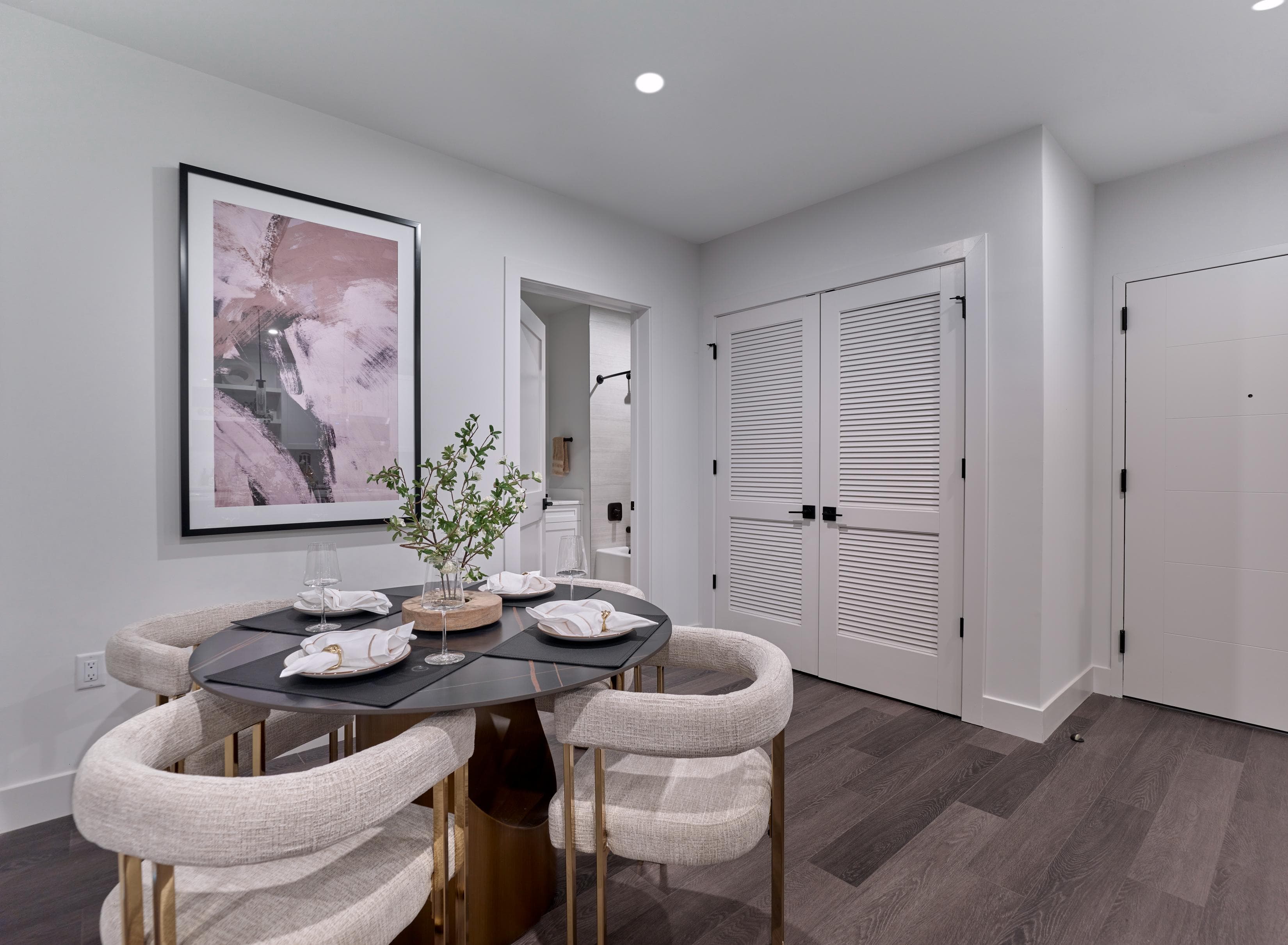 A dining room with a round table and chairs.