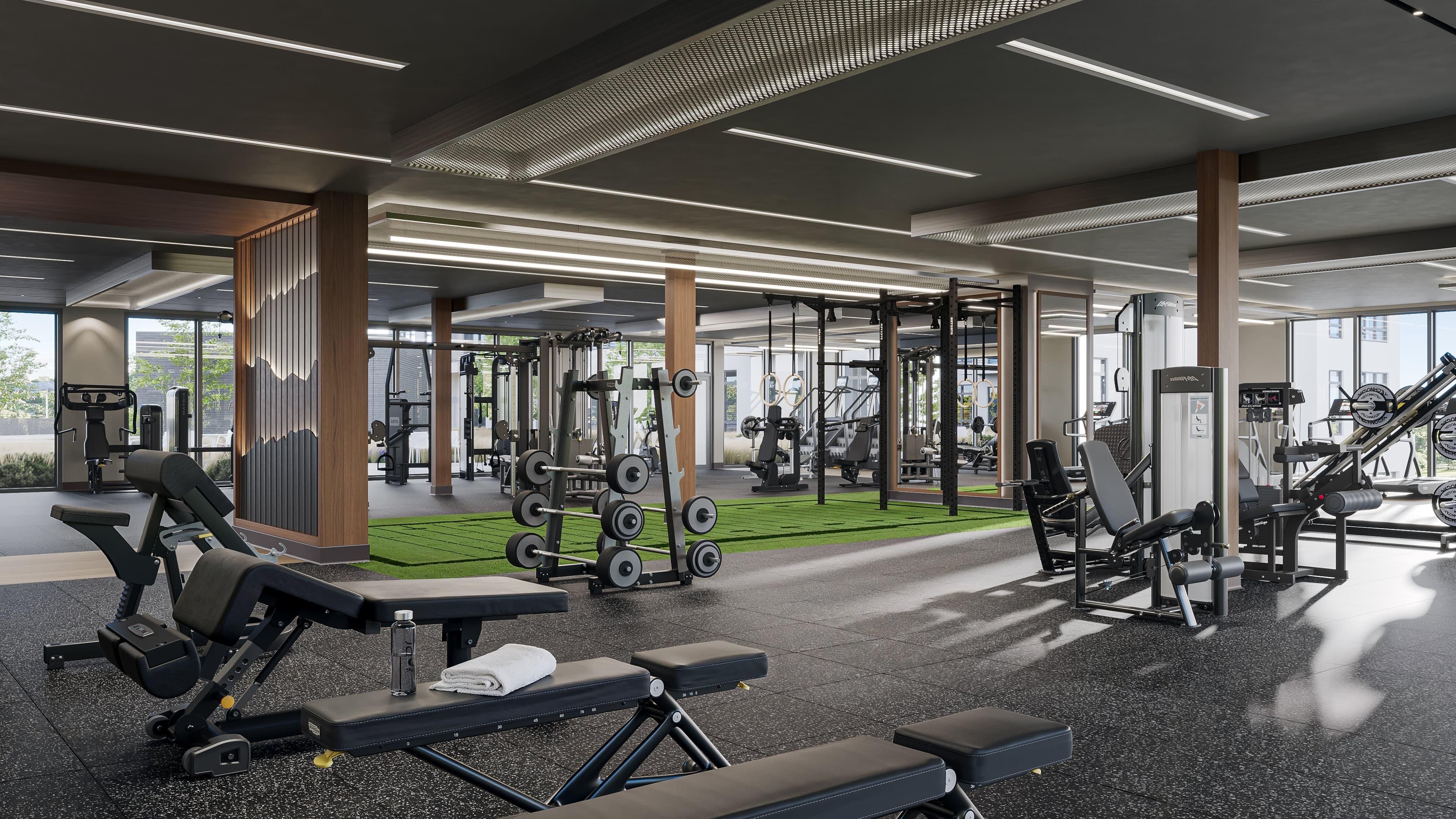 Fitness center with cardio machines, free weights, turf area, personal training