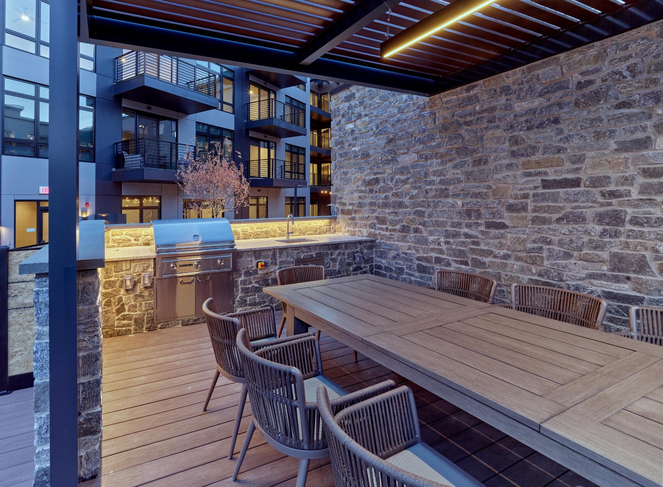 Bar and grill area in resort-style pool courtyard in a luxury apartment rental community in Paramus, NJ.