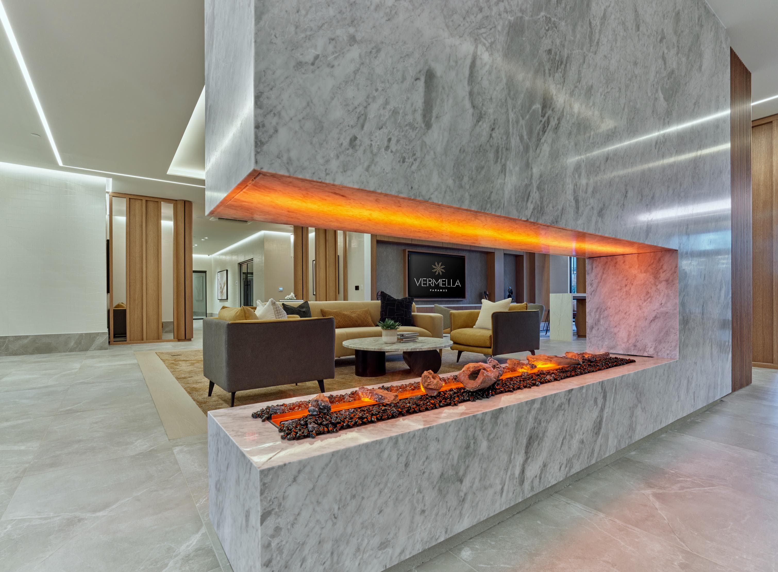 A modern living room with a fireplace and a flat screen TV.