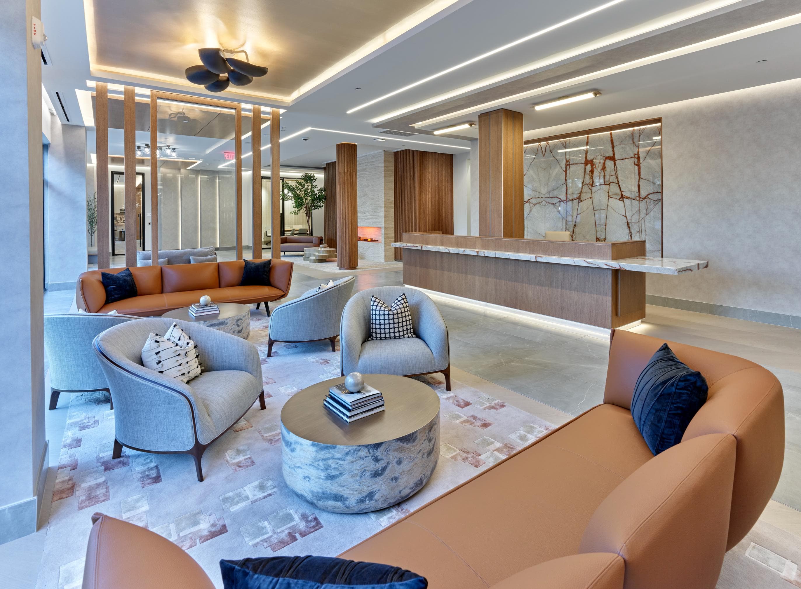 A modern living room with a large sofa, armchairs, and a coffee table.