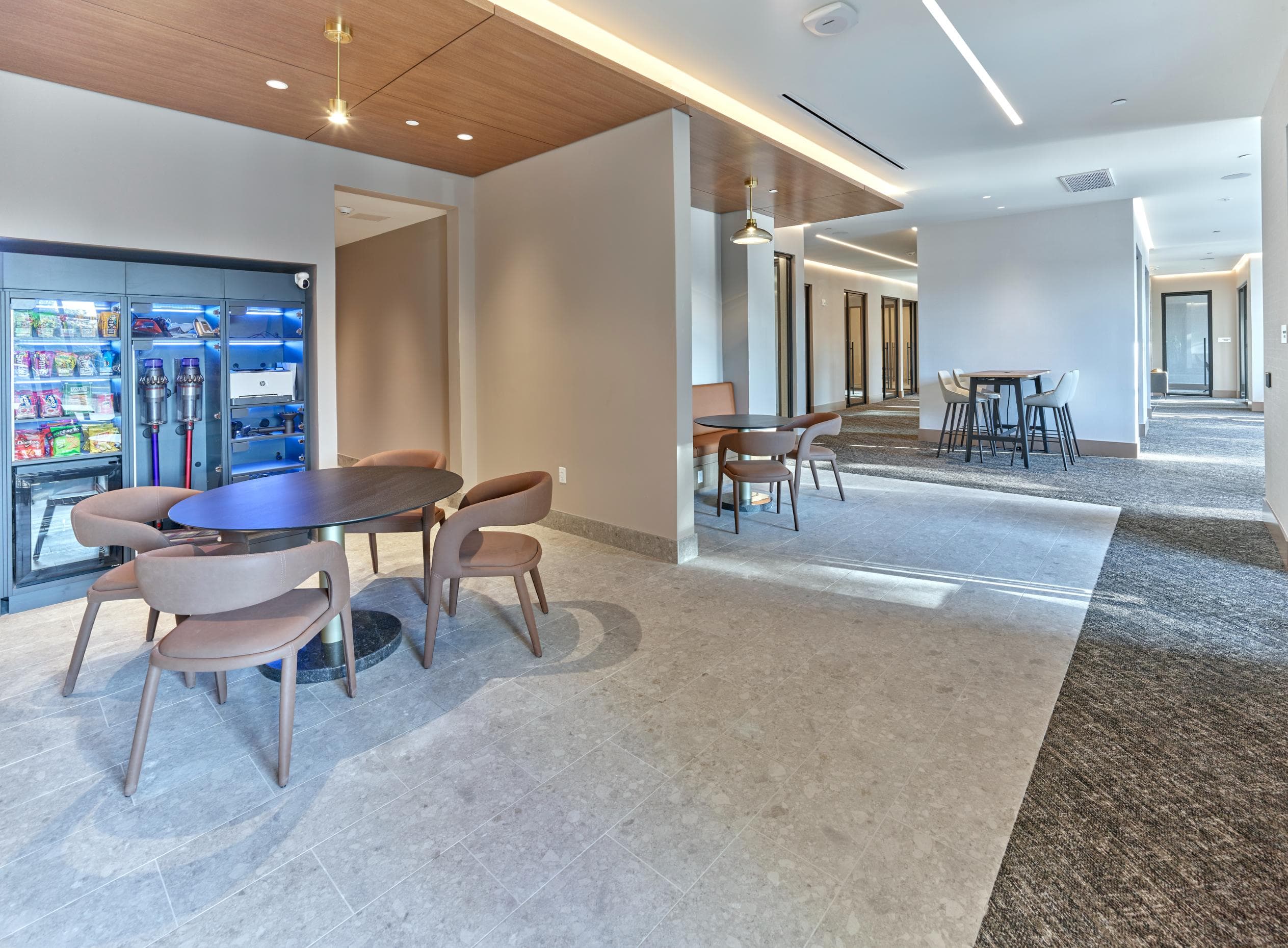 A modern dining area with a circular table surrounded by chairs.