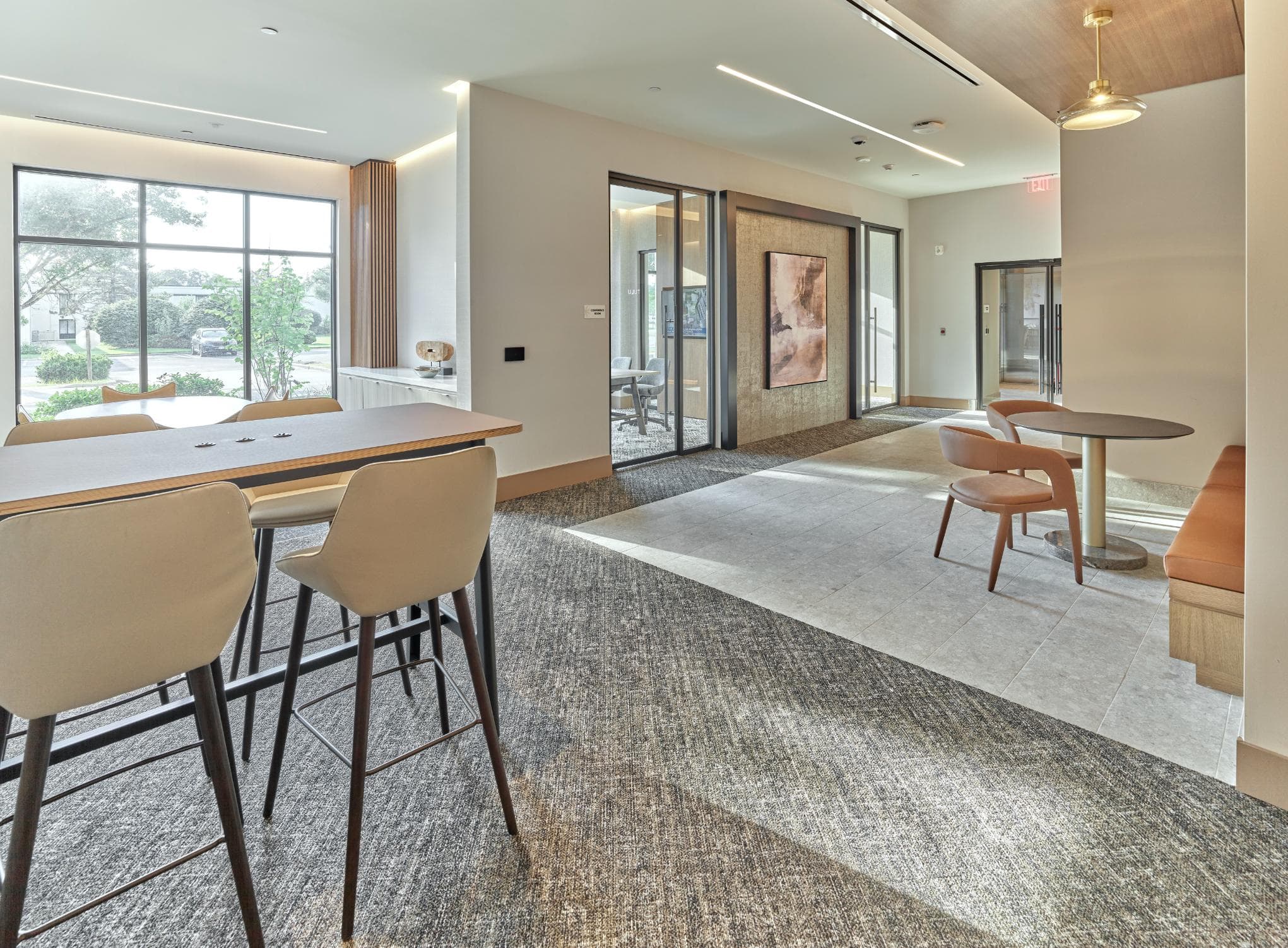 A room with a table and chairs and a carpet.