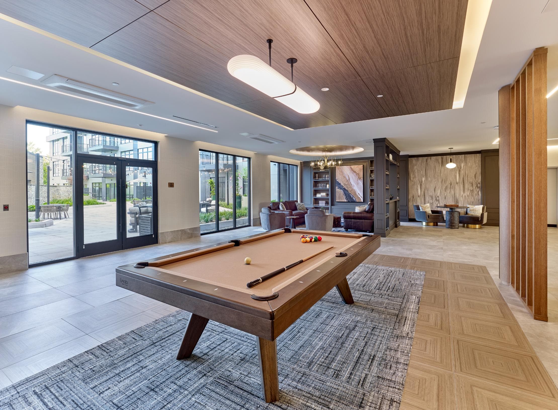 Clubroom with game tables, lounge and bar seating, private theatre, private dining, and fireplace.