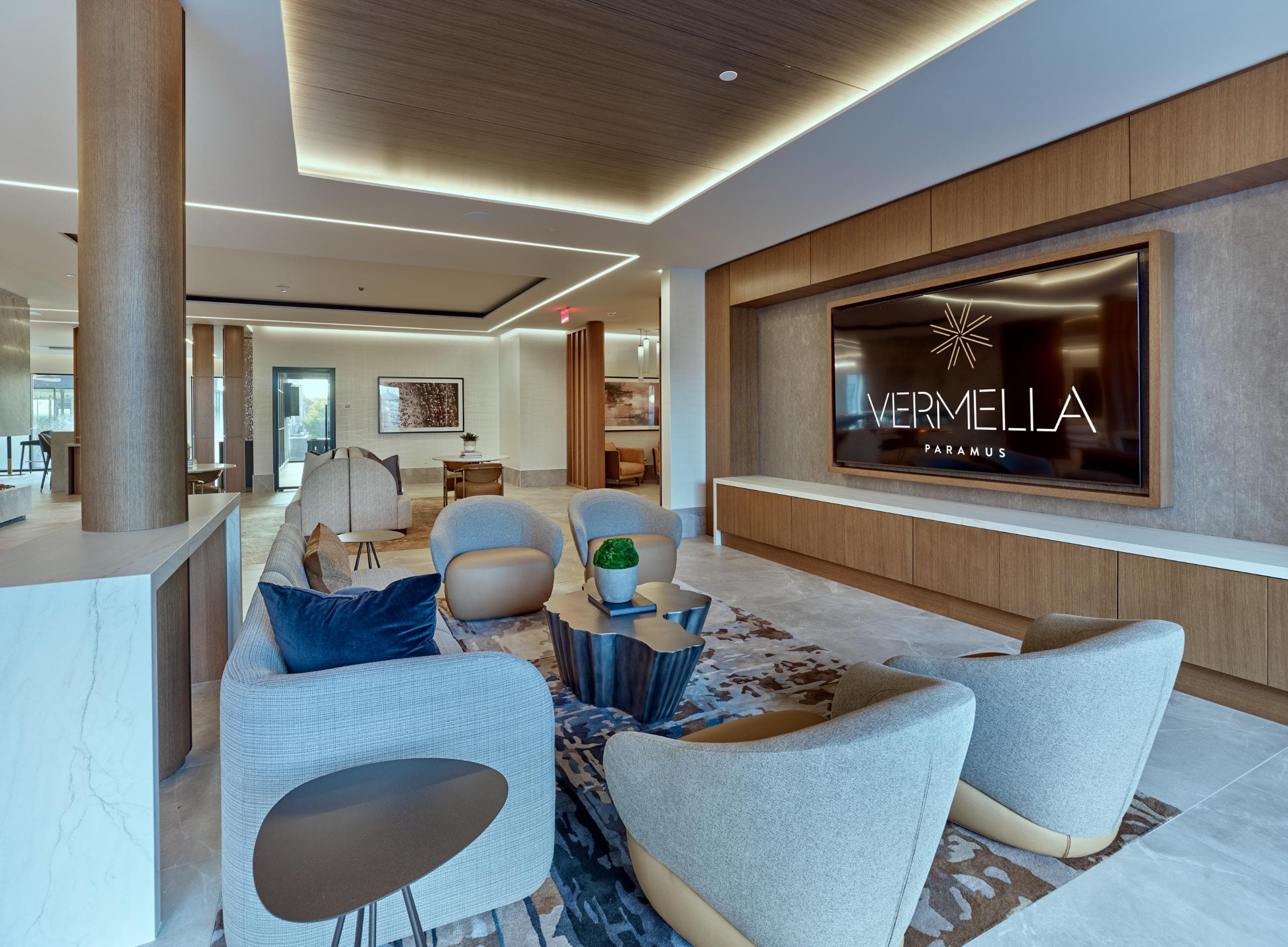 A modern living room with a large screen displaying the text