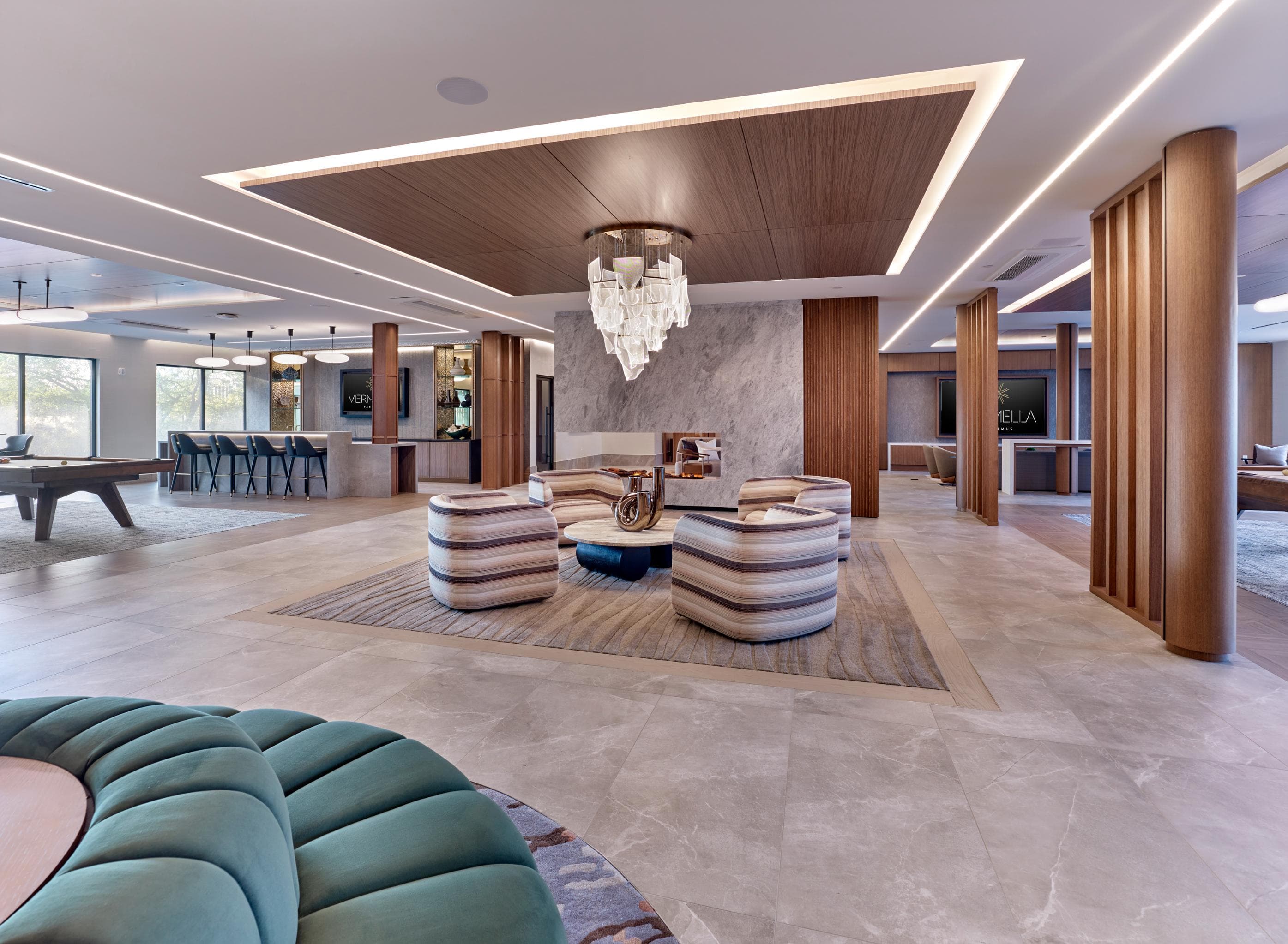 Resident clubroom with game tables and lounge and table sitting.