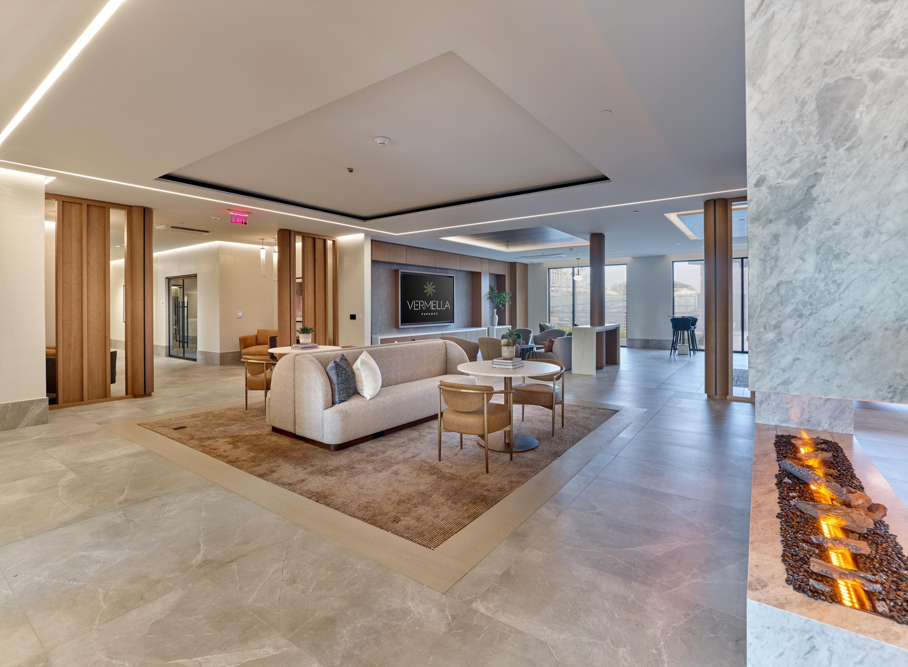 A modern living room with a stone floor and a stone wall.